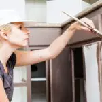 closeup of woman painting kitchen cabinets 2021 08 26 15 42 20 utc scaled 1