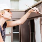 closeup of woman painting kitchen cabinets 2021 08 26 15 42 20 utc scaled - Harpeth Painting LLC