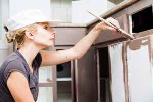 closeup of woman painting kitchen cabinets 2021 08 26 15 42 20 utc scaled - Harpeth Painting LLC